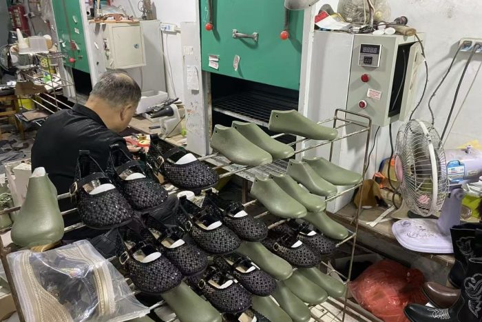 Lasting and shaping a shoe over a wooden last